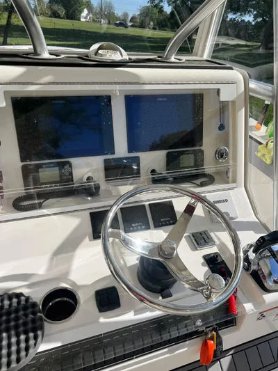  Yacht Photos Pics 2017 Custom Carolina Center Console boat dashboard with steering wheel and navigation screens.