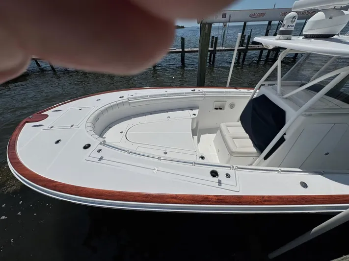  Yacht Photos Pics 2017 Custom Carolina Center Console boat docked by the water.