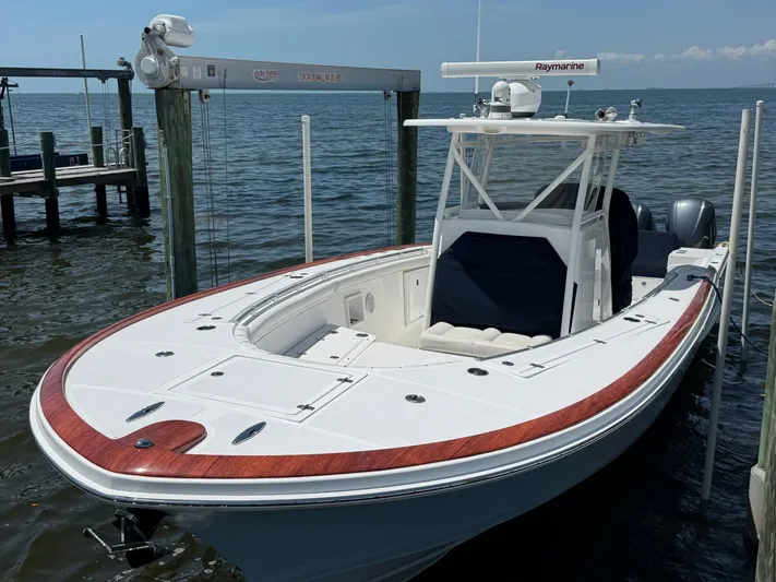  Yacht Photos Pics 2017 Custom Carolina Center Console boat docked on calm water.