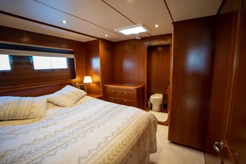  Yacht Photos Pics Luxurious 2018 Nordhavn 60 yacht bedroom with ensuite bathroom, elegant wood finish.