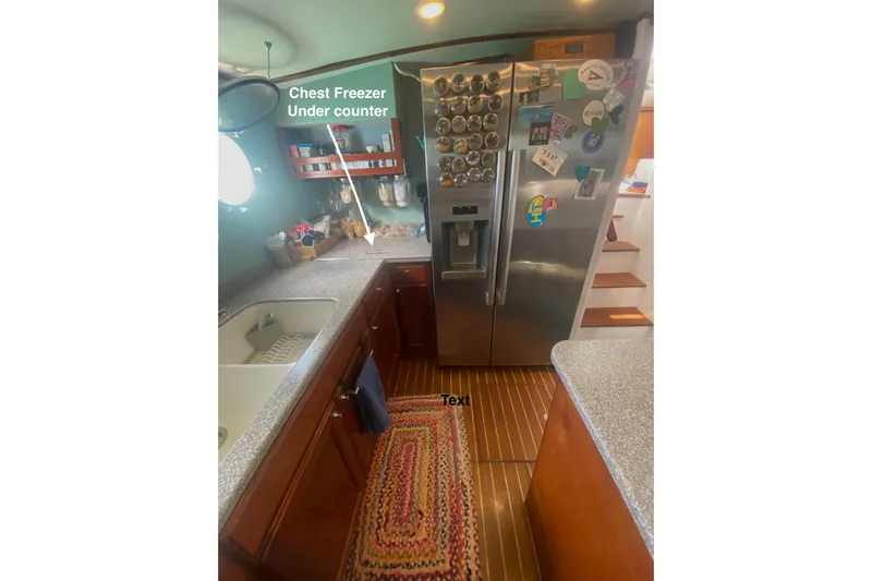 Ten Sigma (formerly Recently Korkzcrew) Yacht Photos Pics 2008 Great Harbour N37 kitchen with stainless steel fridge, wooden cabinets, and under-counter chest freezer.