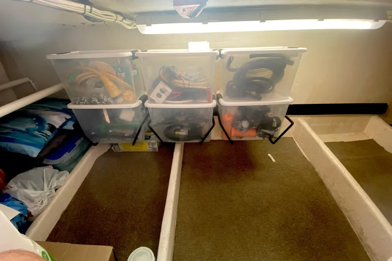 Ten Sigma (formerly Recently Korkzcrew) Yacht Photos Pics Storage area in a 2008 Great Harbour N37 boat with organized plastic bins.