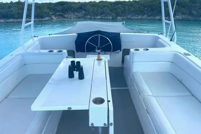 Ten Sigma (formerly Recently Korkzcrew) Yacht Photos Pics 2008 Great Harbour N37 yacht interior with seating, table, and scenic water view.