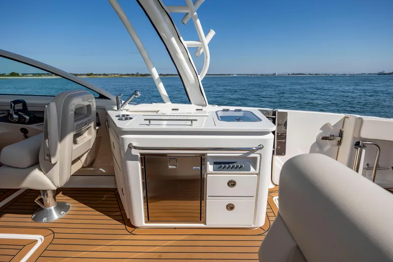  Yacht Photos Pics 2023 Boston Whaler 320 Vantage boat interior with sleek kitchen and ocean view.