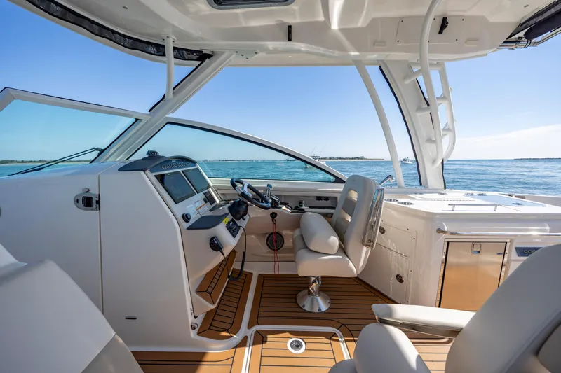  Yacht Photos Pics 2023 Boston Whaler 320 Vantage helm with luxurious seating and ocean view.