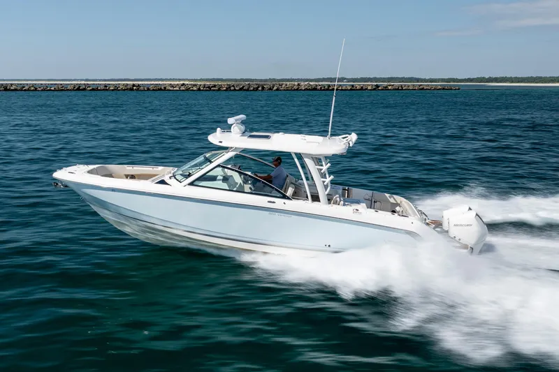  Yacht Photos Pics 2023 Boston Whaler 320 Vantage cruising on open water, showcasing sleek design and performance.