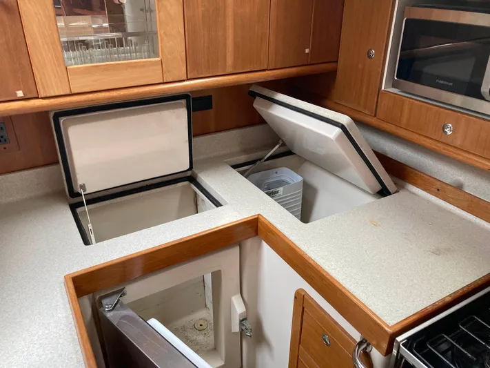  Yacht Photos Pics Galley kitchen in 2008 Catalina 470 yacht with open storage compartments.