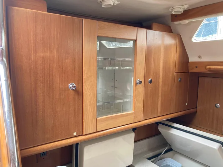  Yacht Photos Pics Wooden cabinetry inside a 2008 Catalina 470 yacht, featuring ample storage and a glass display.