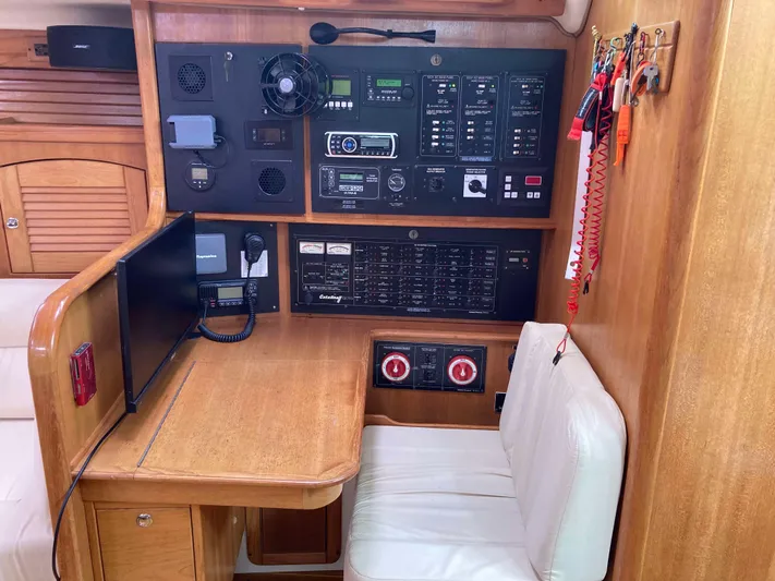  Yacht Photos Pics Navigation station of a 2008 Catalina 470 yacht with control panels and seating.