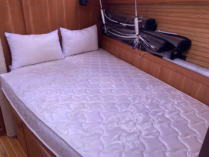  Yacht Photos Pics Cozy cabin bed in 2008 Catalina 470 sailboat with white mattress and pillows.