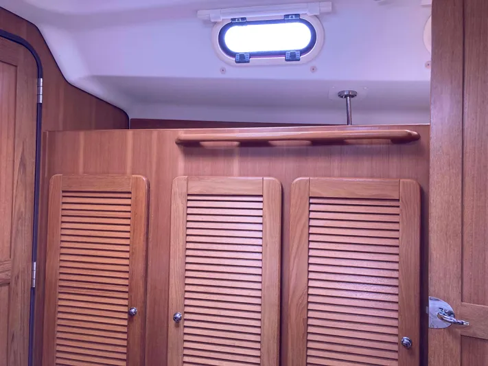  Yacht Photos Pics Interior of 2008 Catalina 470 yacht with wooden cabinets and porthole window.