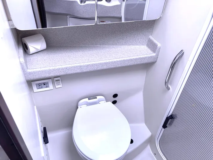  Yacht Photos Pics 2008 Catalina 470 yacht bathroom with toilet, mirror, and shelf.