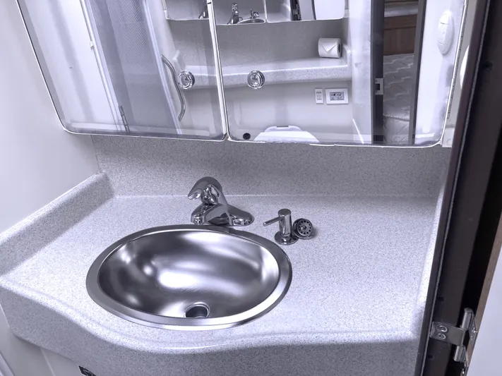  Yacht Photos Pics Modern bathroom sink in a 2008 Catalina 470 yacht, featuring sleek fixtures and mirrored cabinets.