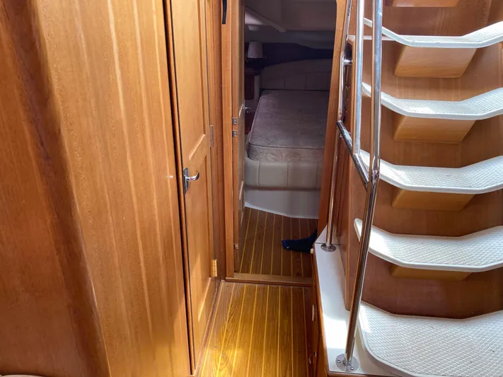  Yacht Photos Pics Interior of 2008 Catalina 470 yacht with wooden flooring and staircase leading to cabin.