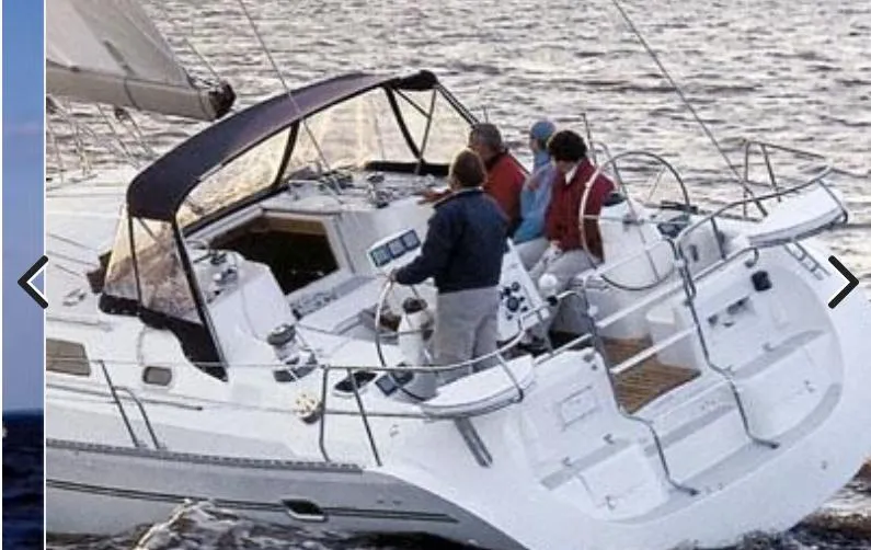  Yacht Photos Pics 2008 Catalina 470 sailboat with crew on deck, sailing on open water.