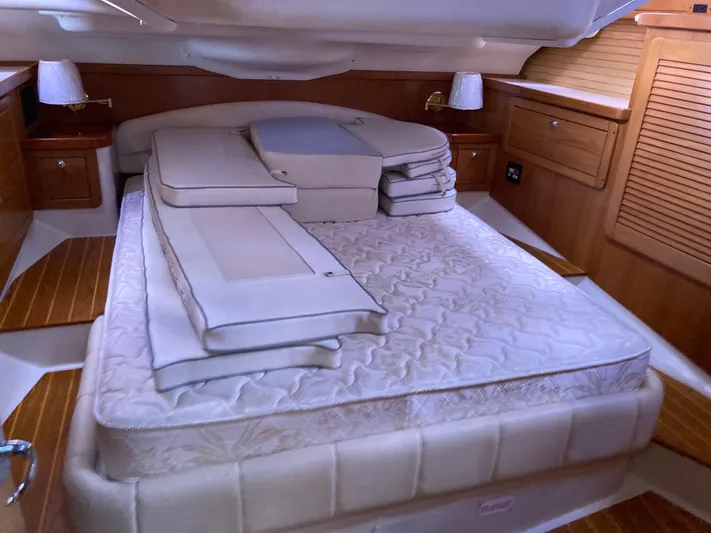  Yacht Photos Pics Luxurious cabin interior of a 2008 Catalina 470 yacht with a neatly arranged bed.