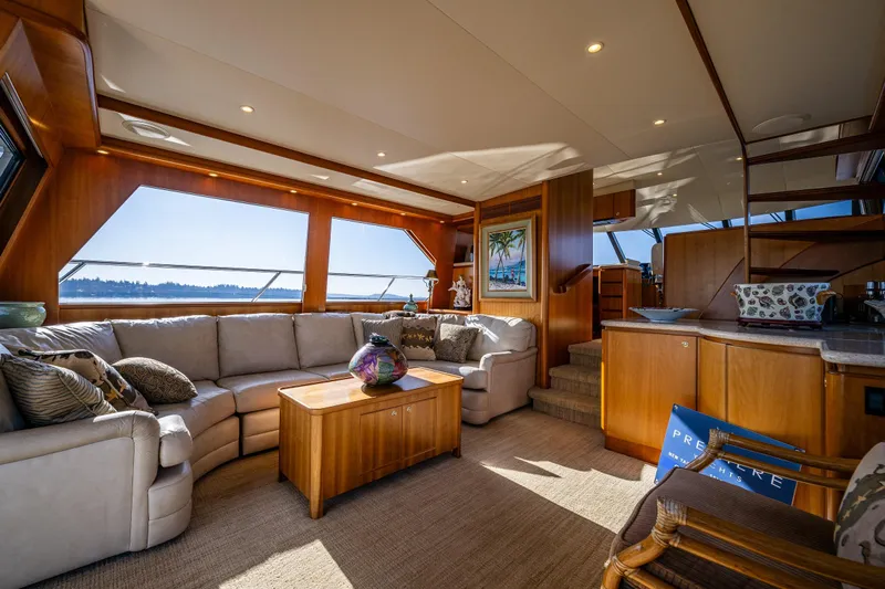 Kolokea Yacht Photos Pics Luxurious interior of 2001 West Bay 58 yacht with elegant wood finishes and plush seating.