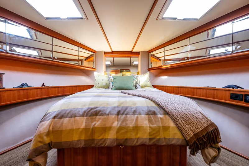 Kolokea Yacht Photos Pics Luxurious bedroom interior of 2001 West Bay 58 yacht with elegant wood finishes.
