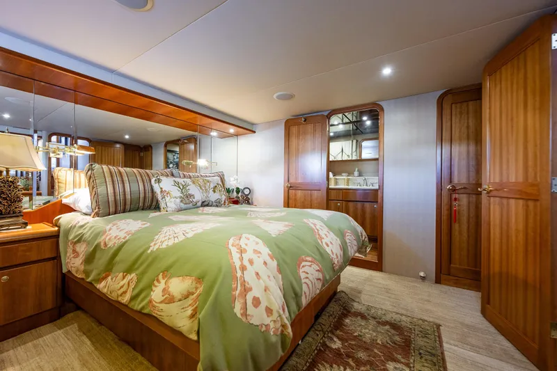 Kolokea Yacht Photos Pics Luxurious bedroom interior of 2001 West Bay 58 yacht with elegant wood finishes and cozy bedding.
