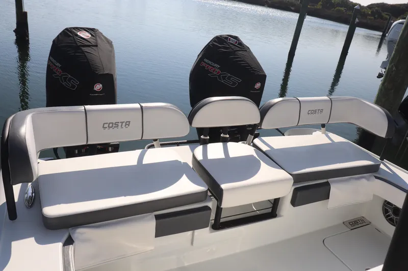  Yacht Photos Pics 2021 Costa Custom Boats 26 with dual Mercury engines, docked on calm water.