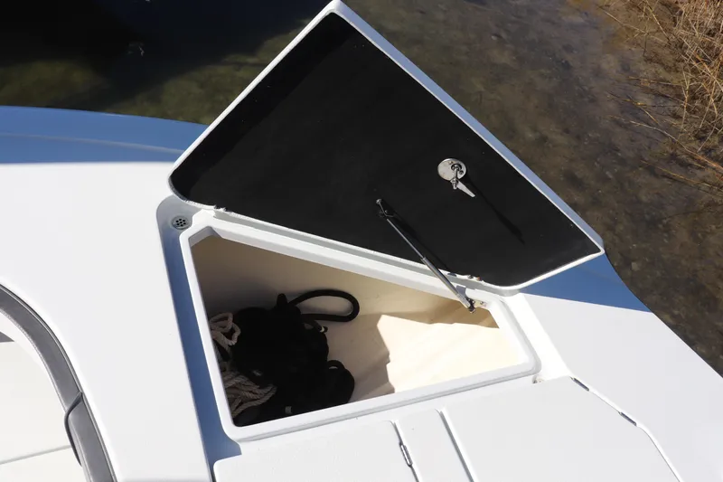  Yacht Photos Pics Open storage compartment on 2021 Costa Custom Boats 26, featuring ropes and a key.