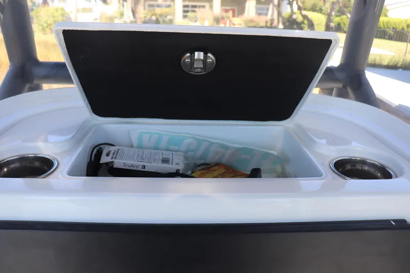  Yacht Photos Pics Open storage compartment on 2021 Costa Custom Boats 26, featuring cup holders and various items inside.