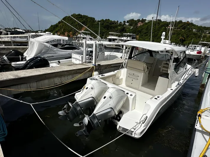  Yacht Photos Pics 2020 Boston Whaler 325 Conquest docked at marina, featuring dual outboard engines.