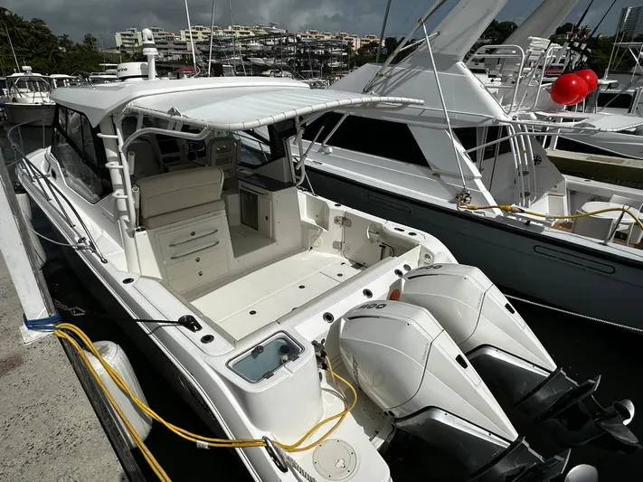  Yacht Photos Pics 2020 Boston Whaler 325 Conquest docked, featuring dual outboard engines and spacious deck.