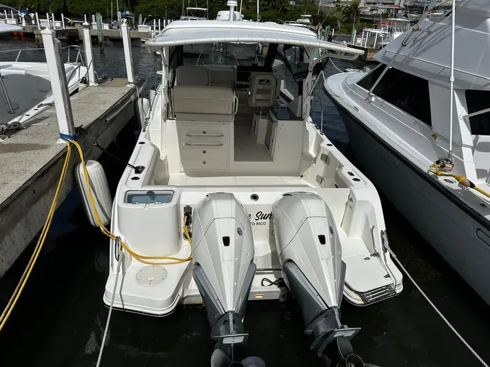  Yacht Photos Pics 2020 Boston Whaler 325 Conquest docked, featuring dual outboard engines and spacious cockpit.