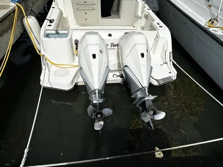  Yacht Photos Pics 2020 Boston Whaler 325 Conquest with dual outboard motors docked in water.