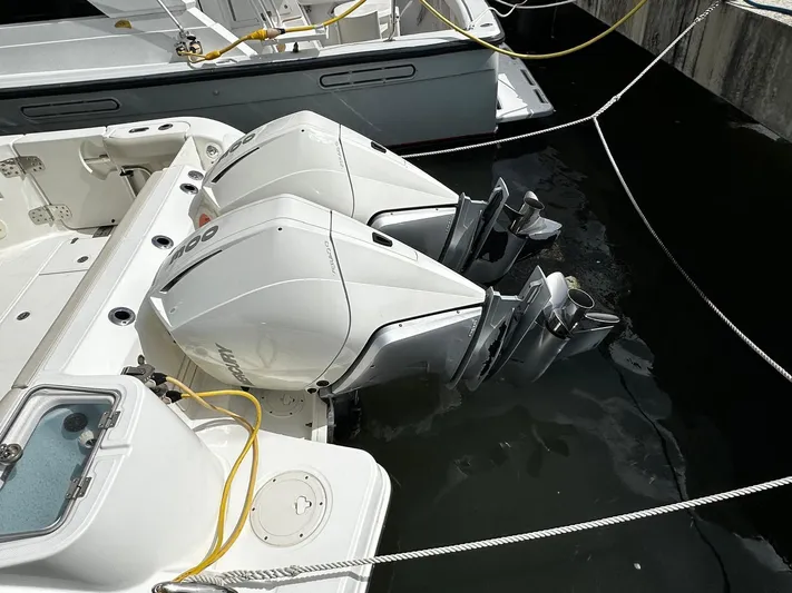 Yacht Photos Pics Twin outboard engines on a 2020 Boston Whaler 325 Conquest boat docked in water.