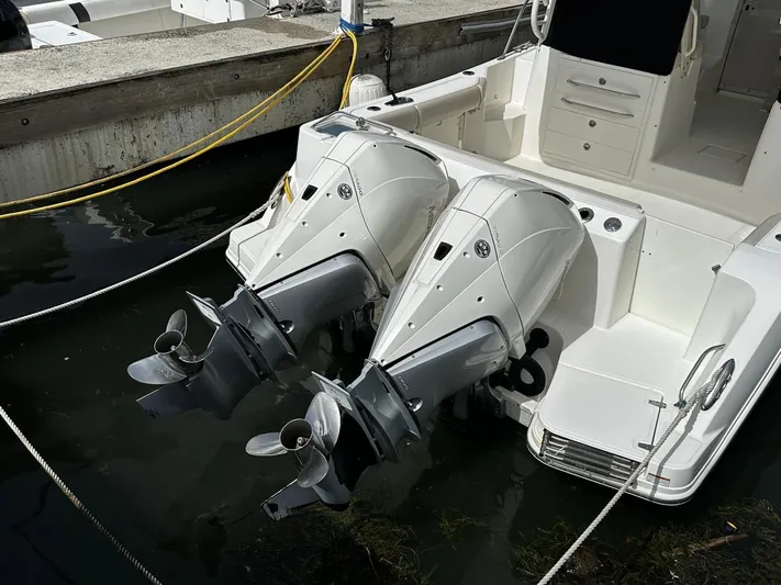  Yacht Photos Pics 2020 Boston Whaler 325 Conquest with dual outboard engines docked at marina.
