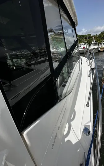  Yacht Photos Pics 2020 Boston Whaler 325 Conquest boat docked, showcasing sleek design and windows.