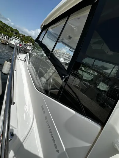  Yacht Photos Pics 2020 Boston Whaler 325 Conquest boat docked at marina, side view.