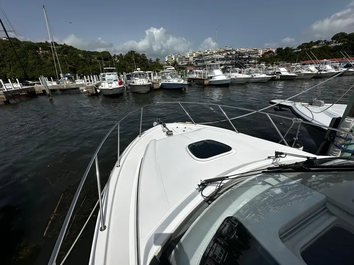  Yacht Photos Pics 2020 Boston Whaler 325 Conquest docked in a marina with other boats.