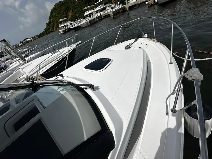  Yacht Photos Pics 2020 Boston Whaler 325 Conquest docked at marina, surrounded by other boats.