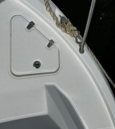  Yacht Photos Pics Close-up of 2020 Boston Whaler 325 Conquest boat deck with rope and hatch.