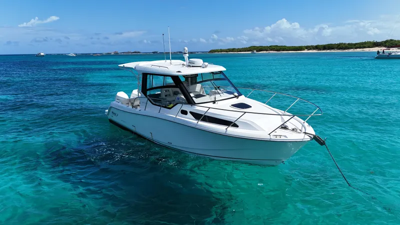  Yacht Photos Pics 2020 Boston Whaler 325 Conquest boat anchored in clear turquoise water.