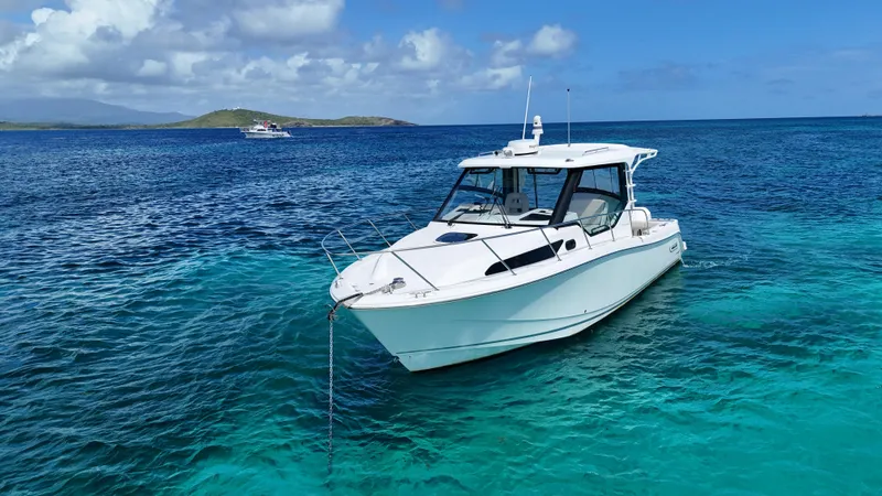  Yacht Photos Pics 2020 Boston Whaler 325 Conquest boat anchored in clear blue ocean waters.