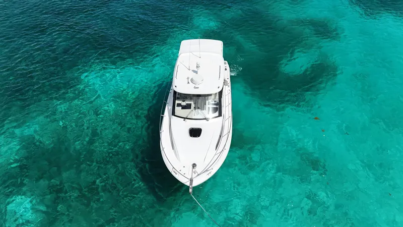 Yacht Photos Pics Boston Whaler 325 Conquest 2020 boat on clear turquoise water, aerial view.