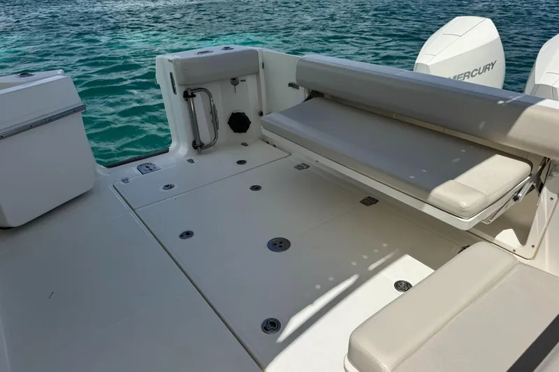  Yacht Photos Pics 2020 Boston Whaler 325 Conquest boat deck with seating, near turquoise water.