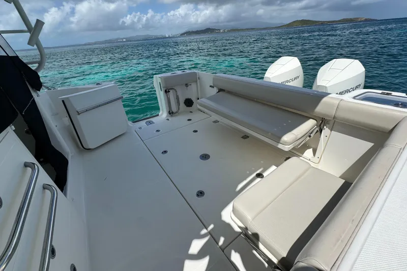  Yacht Photos Pics 2020 Boston Whaler 325 Conquest boat deck with seating, ocean view, and twin Mercury engines.