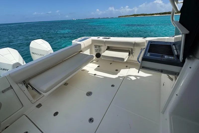  Yacht Photos Pics 2020 Boston Whaler 325 Conquest boat interior with seating, grill, and ocean view.