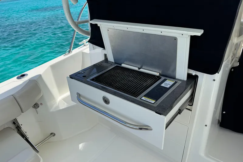  Yacht Photos Pics Outdoor grill on 2020 Boston Whaler 325 Conquest boat, near turquoise water.