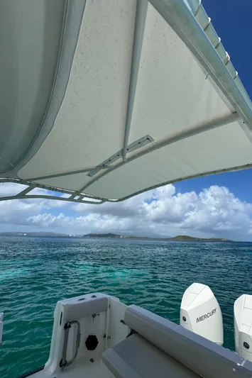  Yacht Photos Pics Boston Whaler 325 Conquest 2020 on serene ocean with Mercury engines, under a canopy.