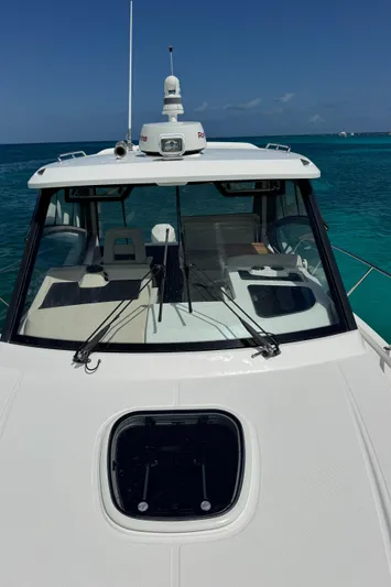  Yacht Photos Pics 2020 Boston Whaler 325 Conquest on turquoise water, showcasing sleek design and advanced features.