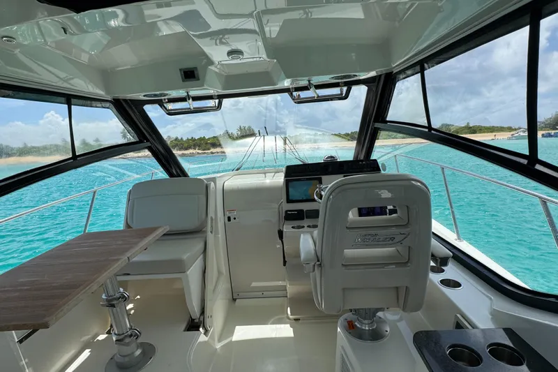  Yacht Photos Pics Interior view of 2020 Boston Whaler 325 Conquest boat with ocean backdrop.