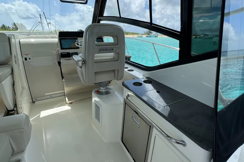  Yacht Photos Pics Interior of 2020 Boston Whaler 325 Conquest boat with helm and kitchenette.