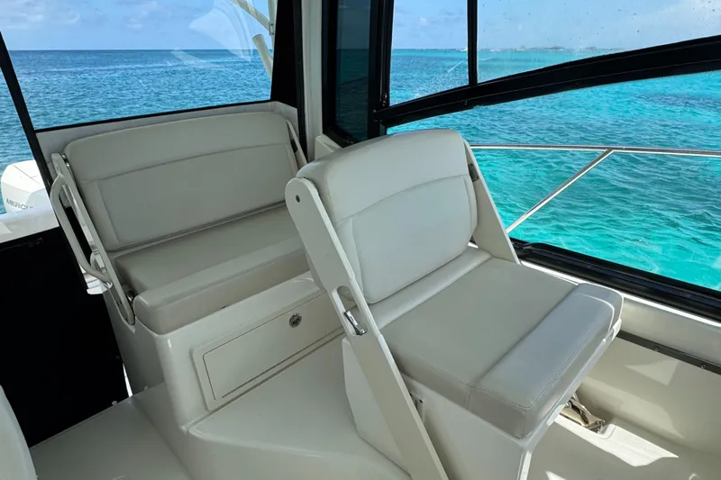  Yacht Photos Pics 2020 Boston Whaler 325 Conquest interior with ocean view, featuring comfortable seating.