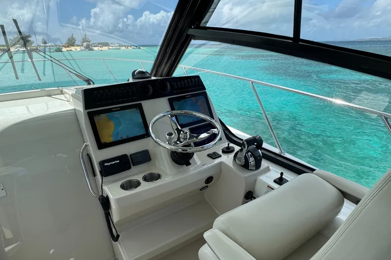  Yacht Photos Pics 2020 Boston Whaler 325 Conquest helm with dual screens, steering wheel, and ocean view.